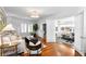 Bright living room featuring hardwood floors, large windows with shutters, and an open layout at 1140 Oak Ne St, St Petersburg, FL 33701