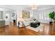 Open-concept living room with hardwood floors, stairs and abundant natural light at 1140 Oak Ne St, St Petersburg, FL 33701