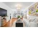 Bright living room featuring hardwood floors, neutral furnishings, and a brick fireplace at 1140 Oak Ne St, St Petersburg, FL 33701