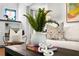 Close up of a living room featuring a vase with green plants and a coffee table with books at 1140 Oak Ne St, St Petersburg, FL 33701
