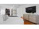 Spacious main bedroom with hardwood floors, TV, walk-in closet, and calming neutral decor at 1140 Oak Ne St, St Petersburg, FL 33701