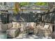 Relaxing patio with cushioned seating, a modern fire pit, and privacy fence at 1140 Oak Ne St, St Petersburg, FL 33701