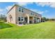 Expansive backyard featuring a well-manicured lawn, covered patio, and views of the surrounding landscape at 11575 84Th Street E Cir # 104, Parrish, FL 34219