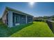 A covered and screened lanai overlooks a fully fenced-in backyard with lush green grass at 11924 Persian Ter, Bradenton, FL 34212