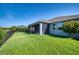 Home features a screened lanai overlooking a lush green lawn and landscaped backyard at 11924 Persian Ter, Bradenton, FL 34212