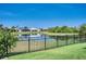 Landscaped backyard with an elegant black fence overlooking a serene pond at 11924 Persian Ter, Bradenton, FL 34212