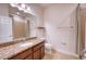 Bright bathroom featuring granite countertops, modern fixtures, and tile flooring at 11924 Persian Ter, Bradenton, FL 34212