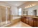 Bright primary bathroom with tiled floors, a glass shower and soaking tub at 11924 Persian Ter, Bradenton, FL 34212