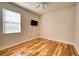 Comfortable bedroom with wood floors, ceiling fan, and mounted TV at 11924 Persian Ter, Bradenton, FL 34212