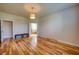 Open bedroom with wood floors, ceiling light, two doors and bench seat at 11924 Persian Ter, Bradenton, FL 34212