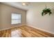 Bright bedroom with wood floors, ceiling fan, and natural light from a window at 11924 Persian Ter, Bradenton, FL 34212