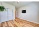 Comfortable bedroom with wood floors, closet, ceiling fan, and mounted TV at 11924 Persian Ter, Bradenton, FL 34212