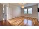 Empty bedroom with wood floors, two windows and a ceiling light at 11924 Persian Ter, Bradenton, FL 34212