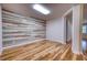 Bonus room featuring wood-look flooring, a modern accent wall, and neutral paint at 11924 Persian Ter, Bradenton, FL 34212