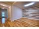Bonus room featuring wood-look flooring, a modern accent wall, and neutral paint at 11924 Persian Ter, Bradenton, FL 34212