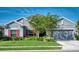 Charming single-story home with a well-manicured lawn, a two car garage, and colorful shutters at 11924 Persian Ter, Bradenton, FL 34212