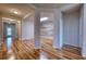 Hallway showcasing stylish wood-look flooring, a modern entryway, and natural lighting at 11924 Persian Ter, Bradenton, FL 34212