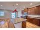 Gourmet kitchen featuring an island, granite countertops, stainless steel appliances, and stylish pendant lights at 11924 Persian Ter, Bradenton, FL 34212