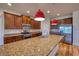 Gourmet kitchen featuring an island, granite countertops, stainless steel appliances, and stylish pendant lights at 11924 Persian Ter, Bradenton, FL 34212