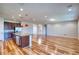Open concept kitchen and living room with wood flooring and recessed lighting at 11924 Persian Ter, Bradenton, FL 34212