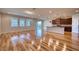 Spacious living room and kitchen with modern wood flooring and plenty of natural light at 11924 Persian Ter, Bradenton, FL 34212