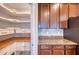 Bright pantry with white shelving and wood countertop provides ample storage at 11924 Persian Ter, Bradenton, FL 34212