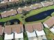 Beautiful aerial view of villas with ponds in a well-maintained community with lush landscaping at 1211 Capri Isles Blvd # 26, Venice, FL 34292