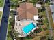 Aerial view of a home with a pool, outdoor seating, and well-maintained landscaping at 1211 Capri Isles Blvd # 26, Venice, FL 34292