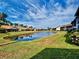 Beautiful view of backyard pond, surrounded by lush green lawns and neighboring houses at 1211 Capri Isles Blvd # 26, Venice, FL 34292