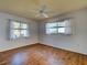 Bright, comfortable bedroom with wood-look flooring, neutral walls, and a ceiling fan at 1211 Capri Isles Blvd # 26, Venice, FL 34292