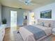 Bright bedroom with tile floors, ceiling fan, and ensuite bathroom at 1211 Capri Isles Blvd # 26, Venice, FL 34292