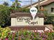 Community sign for Fairways of Capri with colorful flowers and manicured landscaping at 1211 Capri Isles Blvd # 26, Venice, FL 34292