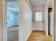Open entryway leading to living area and featuring wood-look tile flooring and neutral paint at 1211 Capri Isles Blvd # 26, Venice, FL 34292
