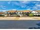 Two-story condos with covered parking, with well-maintained lawn and a palm tree at 1211 Capri Isles Blvd # 26, Venice, FL 34292