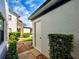 Exterior view of building with additional storage and lush landscaping in a community setting at 1211 Capri Isles Blvd # 26, Venice, FL 34292