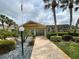 Exterior view of a well-maintained home with beautiful landscaping and a paved walkway at 1211 Capri Isles Blvd # 26, Venice, FL 34292