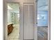 Hallway shot shows the bathroom, laundry closet, and bedroom, creating an open flow throughout the space at 1211 Capri Isles Blvd # 26, Venice, FL 34292