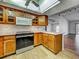 Bright kitchen with tile floors, stone countertops, and modern appliances at 1211 Capri Isles Blvd # 26, Venice, FL 34292