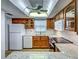 Kitchen with granite countertops, white appliances, and lots of natural light at 1211 Capri Isles Blvd # 26, Venice, FL 34292