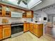 Bright kitchen with tile floors, stone countertops, and modern appliances at 1211 Capri Isles Blvd # 26, Venice, FL 34292
