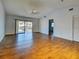 Open living room with tile floors, ceiling fan, and sliding glass doors to patio at 1211 Capri Isles Blvd # 26, Venice, FL 34292