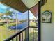 Screened patio with a picturesque view of the pond and surrounding landscaping at 1211 Capri Isles Blvd # 26, Venice, FL 34292