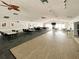 Spacious recreation room featuring ample seating, ceiling fans, and modern lighting fixtures at 1211 Capri Isles Blvd # 26, Venice, FL 34292