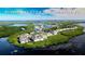 Aerial view of Perico Bay Club in Bradenton, Florida with waterfront homes, lakes, and greenery at 1211 Spoonbill Landings Cir, Bradenton, FL 34209