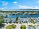 Picturesque aerial view of a waterfront community with lush landscaping, serene water, and well-maintained homes at 1211 Spoonbill Landings Cir, Bradenton, FL 34209