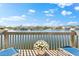 Waterfront deck with flower pot and railings providing a relaxing view of the lake at 1211 Spoonbill Landings Cir, Bradenton, FL 34209