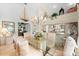 Elegant dining room with a glass top table, chandelier, and nautical-themed decor at 1211 Spoonbill Landings Cir, Bradenton, FL 34209