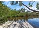 Private dock surrounded by lush trees providing waterfront living and direct access to the water at 1211 Spoonbill Landings Cir, Bradenton, FL 34209