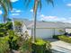 Charming home with mature landscaping, gray roof, and a two-car garage at 1211 Spoonbill Landings Cir, Bradenton, FL 34209