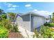 Attached two-car garage with a well-maintained driveway and lush landscaping at 1211 Spoonbill Landings Cir, Bradenton, FL 34209
